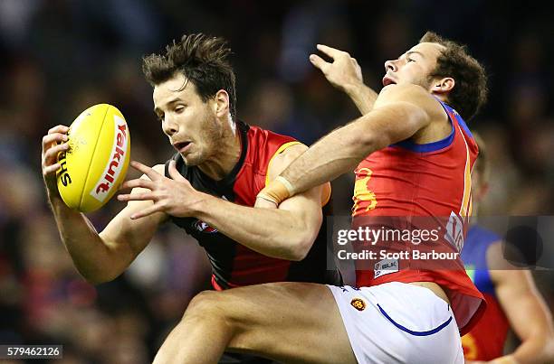 Matt Dea of the Bombers competes for the ball during the round 18 AFL match between the Essendon Bombers and the Brisbane Lions at Etihad Stadium on...