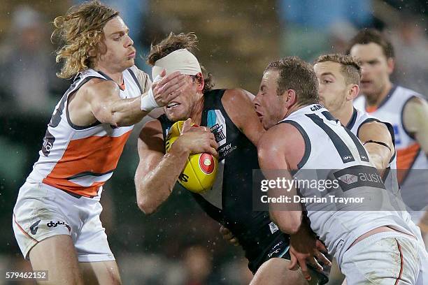 Steve Johnson of the Giants tackles Brad Ebert of the Power during the round 18 AFL match between the Port Adelaide Power and the Greater Western...