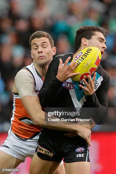 Chad Wingard of the Power marks the ball in front of Joshua Kelly of the Giants during the round 18 AFL match between the Port Adelaide Power and the...