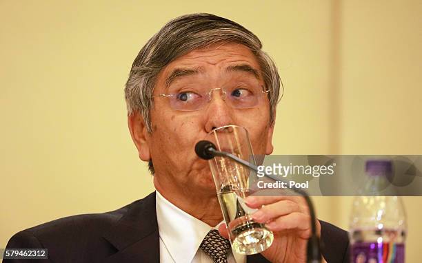 Governor of the Bank of Japan Haruhiko Kuroda sips from a glass during a press conference held at the close of the G20 Finance Ministers and Central...