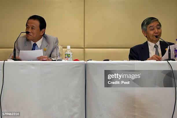 Japan's Deputy Prime Minister Taro Aso and Governor of the Bank of Japan Haruhiko Kuroda attend a press conference held at the close of the G20...