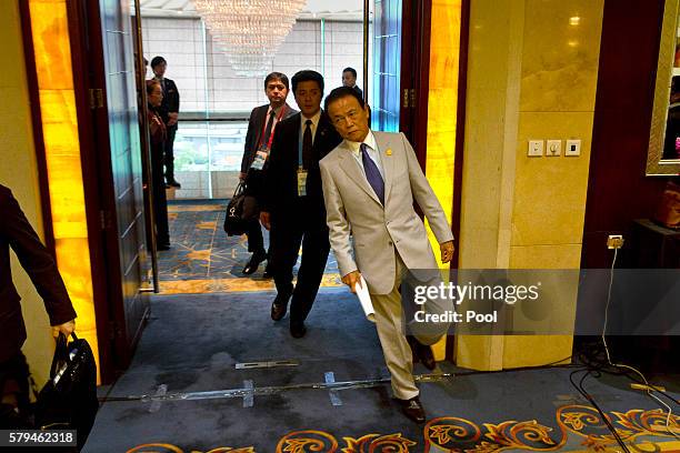 Japan's Deputy Prime Minister Taro Aso arrives for a press conference held at the close of the G20 Finance Ministers and Central Bank Governors...
