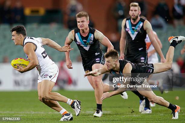 Dylan Shiel of the Giants breaks a Robbie Gray of the Power tackle during the round 18 AFL match between the Port Adelaide Power and the Greater...