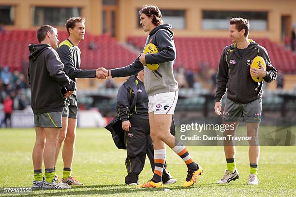 Phil Davis of the Giants shakes hand with the umpires before the round 18 AFL match between the Port Adelaide Power and the Greater Western Sydney...