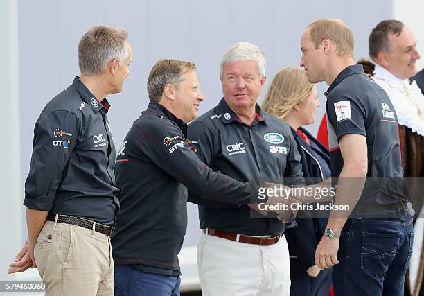 Prince William, Duke of Cambridge greets Martin Whitmarsh , Sir Charles Dunstone and Sir Keith Mills as he visits the Land Rover BAR at the America's...