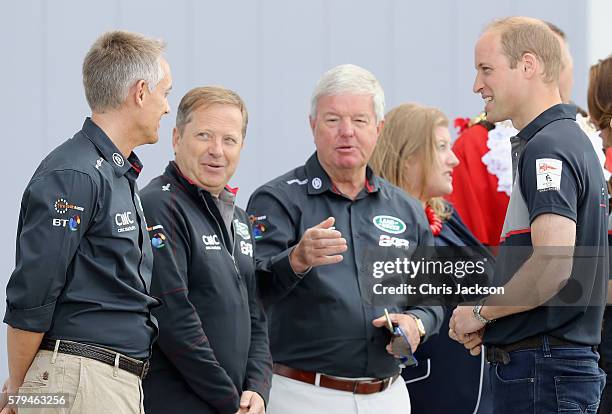 Prince William, Duke of Cambridge greets Martin Whitmarsh , Sir Charles Dunstone and Sir Keith Mills as he visits the Land Rover BAR at the America's...