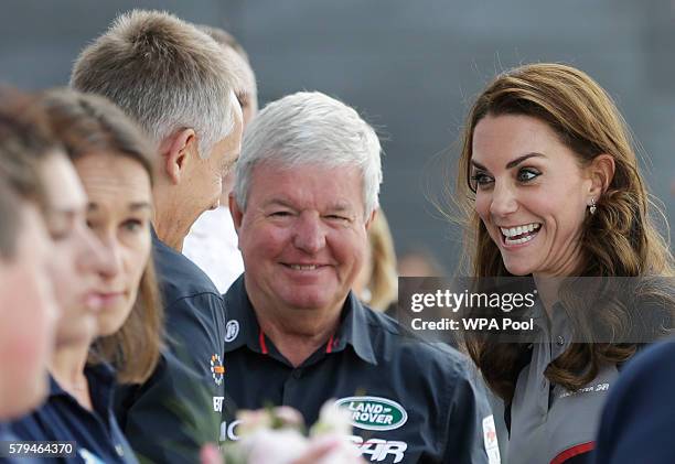 Catherine, Duchess of Cambridge meets with Keith Mills and Martin Whitmarsh , members of the 1851 Trust during a visit to Land Rover BAR at the...