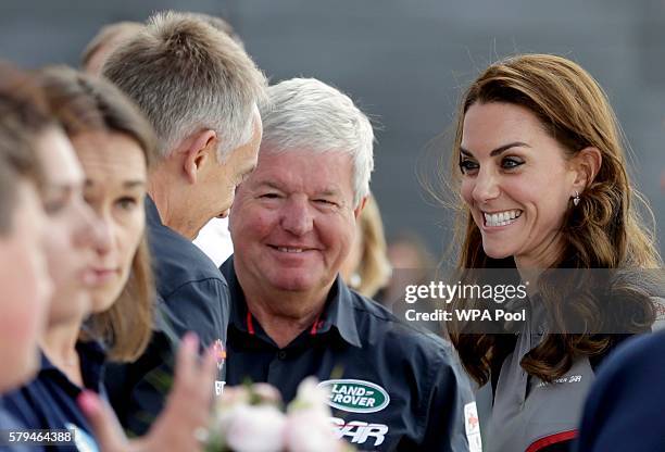 Catherine, Duchess of Cambridge meets with Keith Mills and Martin Whitmarsh , members of the 1851 Trust during a visit to Land Rover BAR at the...