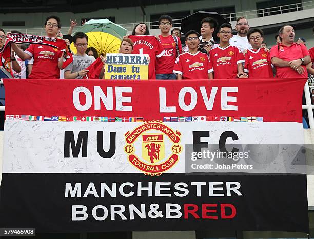 Manchester United fans watch from the stand during a first team training session as part of their pre-season tour of China at Olympic Sports Centre...