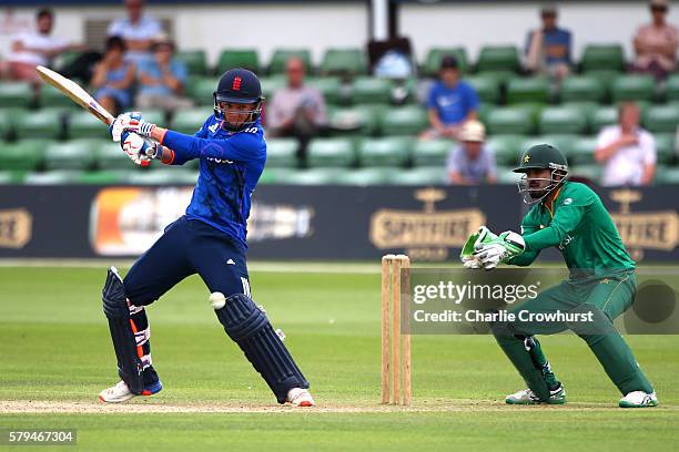Sam Curran of England hits out while Pakistan wicket keeper Umar Siddiq looks on during the Triangular Series match between England Lions and...