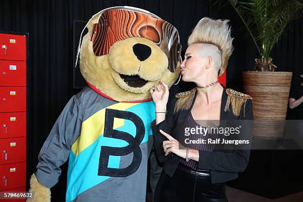 Miriam Nervo and Breuni-Baer, mascot of Breuninger, pose for a photograph at the ParookaVille Festival on July 15, 2016 in Weeze, Germany.
