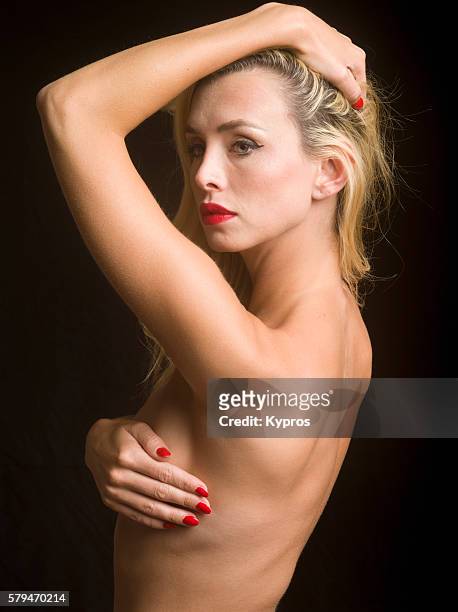 young caucasian woman covering her chest with her arms, close up, studio shot - risque woman stock pictures, royalty-free photos & images