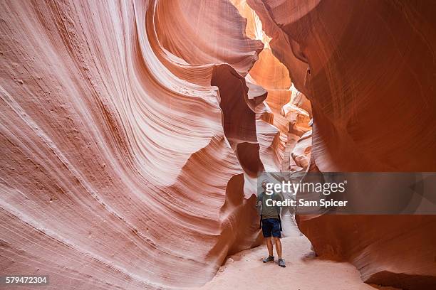 male tourist hiker and sandstone rock formations, lower antelope canyon, page, arizona, usa - slot canyon stock pictures, royalty-free photos & images