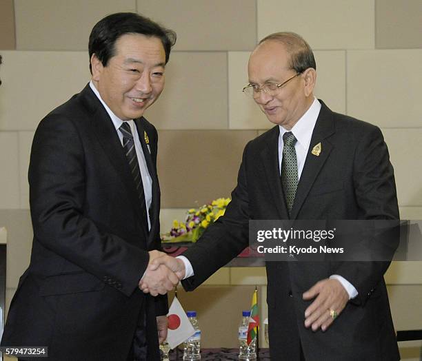 Indonesia - Japanese Prime Minister Yoshihiko Noda and Myanmar President Thein Sein shake hands as they met on the sidelines of regional summits in...