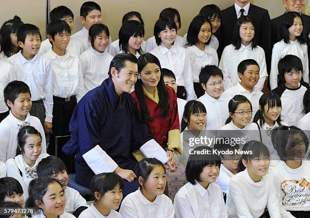 Soma, Japan - Bhutan's King Jigme Khesar Namgyel Wangchuck and Queen Jetsun Pema pose for photos with pupils at Sakuragaoka Elementary School in the...