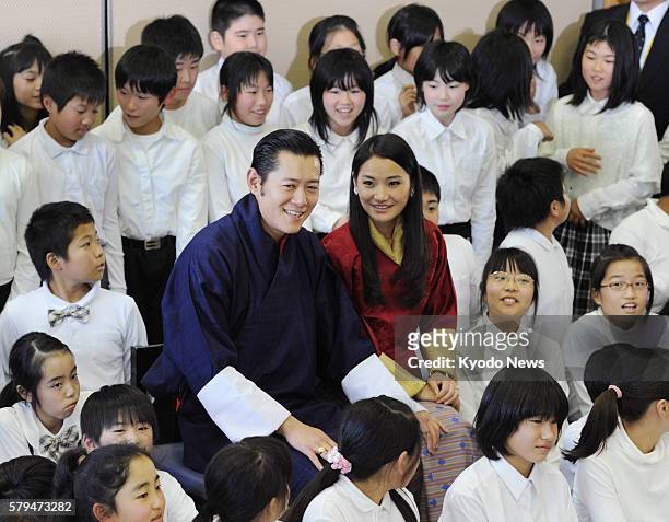 Soma, Japan - Bhutan's King Jigme Khesar Namgyel Wangchuck and Queen Jetsun Pema pose for photos with pupils at Sakuragaoka Elementary School in the...