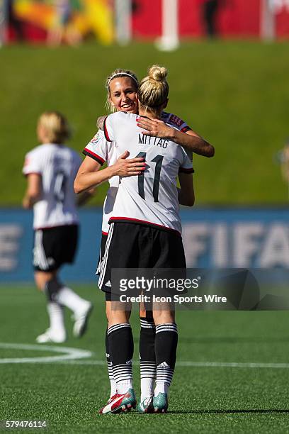 Anja Mittag of Germany celebrates with a teammate after defeating Sweden 4-1 to advance to the next round at the FIFA 2015 Women's World Cup Round of...