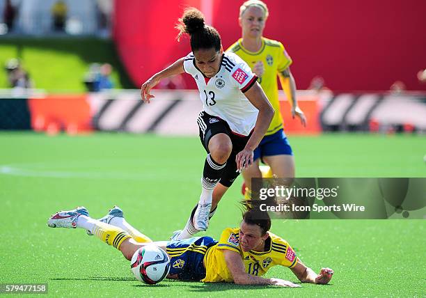 Scorer of Germany's 2nd goal Celia Sasic jumps over the sliding tackle of Jessica Samuelsson of Sweden during the FIFA 2015 Women's World Cup Round...