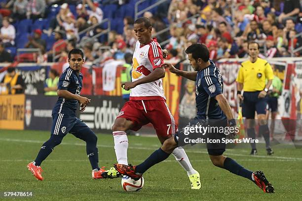 New York Red Bulls defender Roy Miller battles Vancouver FC defender/midfielder Steven Beitashour during the second half of the game between the New...