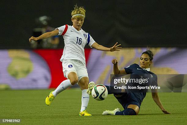 /Louisa Necib of France slide tackles Yumi Kang of the Korea Republic during the first half at the FIFA Women's World Cup 2015 Group of 16 match...