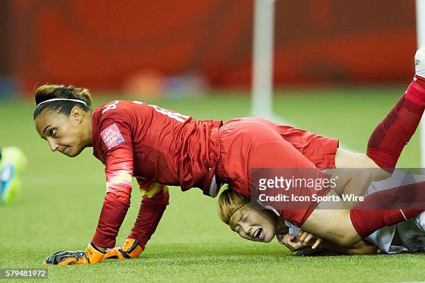 Gaeul Jeon of the Korea Republic is taken down by Goalkeeper Celine Deville of France at the FIFA Women's World Cup 2015 Group of 16 match between...