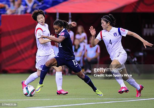 Midfielder Elodie Thomis of France attempts to get away from defender Shim Seojeon of Korea Republicduring the FIFA 2015 Women's World Cup Round of...