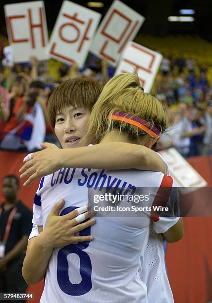 Midfielder Cho Sohyun of Korea Republic is consoled by team matte after the 3-0 defeat to France in the FIFA 2015 Women's World Cup Round of 16 match...