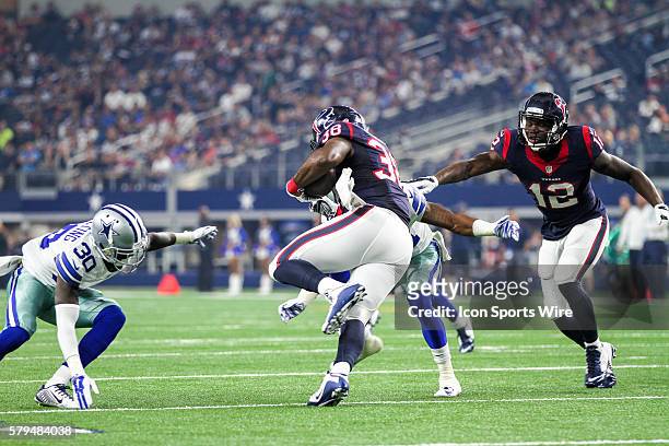 Houston Texans running back Kenny Hilliard tries to run over Dallas Cowboys defensive back Tim Scott during the NFL preseason game between the...