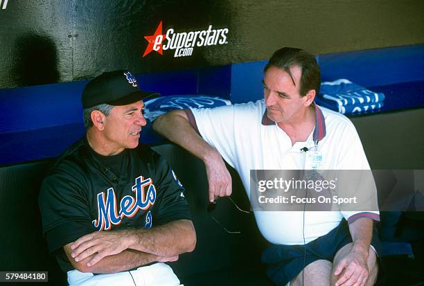 Manager Bobby Valentine of the New York Mets talks with a reporter in the dugout prior to the start of a Major League Baseball spring training game...