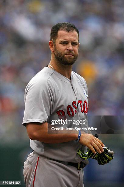 Boston Red Sox first baseman Mike Napoli [6085] removes his batting gloves following a ground out in a 13-2 win against the Kansas City Royals at...