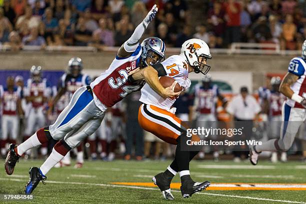 Montreal Alouettes linebacker Kyries Hebert tackles BC Lions quarterback Travis Lulay during a CFL game between the BC Lions and the Montreal...