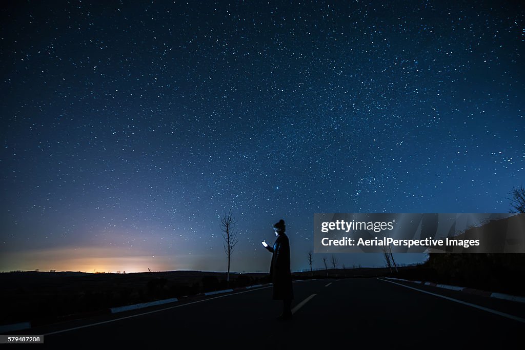 Girl Using A Mobile Phone in Starry night