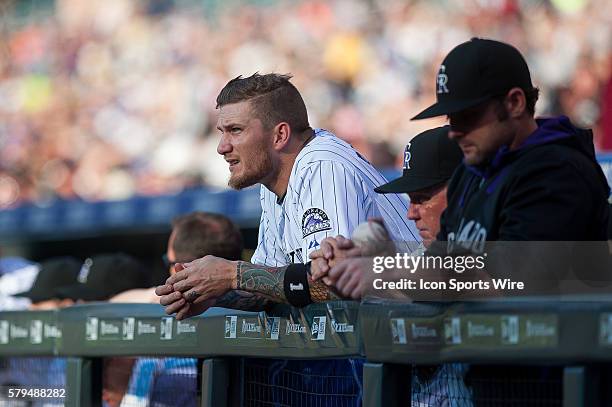 Colorado Rockies left fielder Brandon Barnes looks out from the dugout during a regular season Major League Baseball game between the Milwaukee...