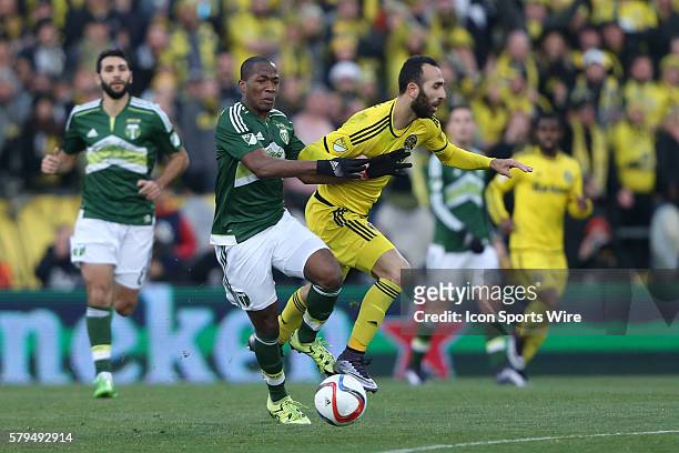 Columbus's Justin Meram is knocked off of the ball by Portland's Darlington Nagbe . The Columbus Crew SC hosted the Portland Timbers FC at Mapfre...