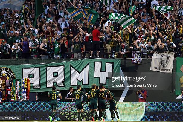 Portland's Gaston Fernandez celebrates his goal with teammates in front of the Timbers Army. The Portland Timbers FC hosted the Houston Dynamo at...