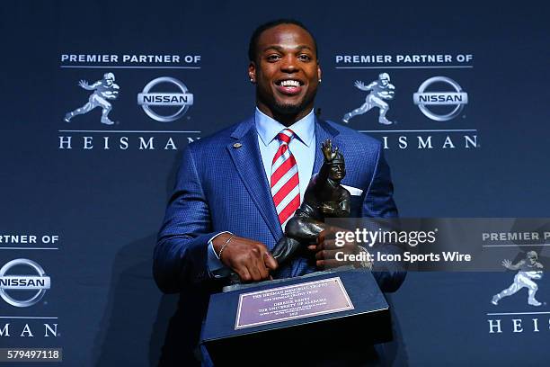 Derrick Henry Running Back University of Alabama poses with the Heisman Trophy during a press conference after winning the Heisman Trophy at the 81st...