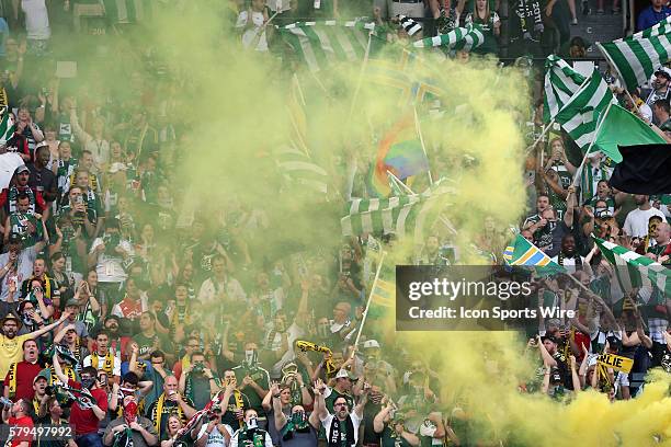 Portland fans in the Timbers Army celebrate a goal with large banners, flags, and smoke. The Portland Timbers FC hosted the Houston Dynamo at...