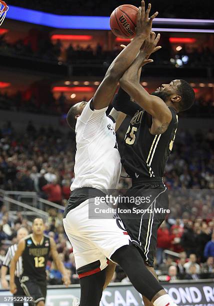 Cincinnati Bearcats forward Gary Clark blocks a shot by Purdue Boilermakers guard Rapheal Davis in a second-round NCAA Tournament game between the...