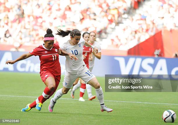 England midfielder Karen Carney and Canadian midfielder Desiree Scott race for the ball during the quarterfinals at BC Place in Vancouver, British...