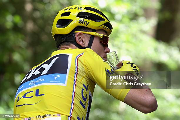 Chris Froome of Great Britain and Team Sky celebrates on the final day by drinking from a glass of champagne during stage twenty one of the 2016 Le...