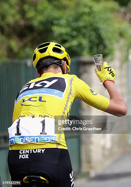 Chris Froome of Great Britain and Team Sky celebrates on the final day by drinking from a glass of champagne during stage twenty one of the 2016 Le...