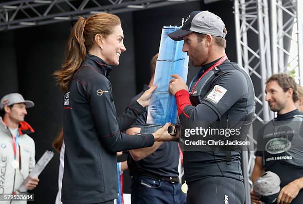 Catherine, Duchess of Cambridge presents Sir Ben Ainslie with the America's Cup 2016 trophy on stage at the America's Cup World Series on July 24,...