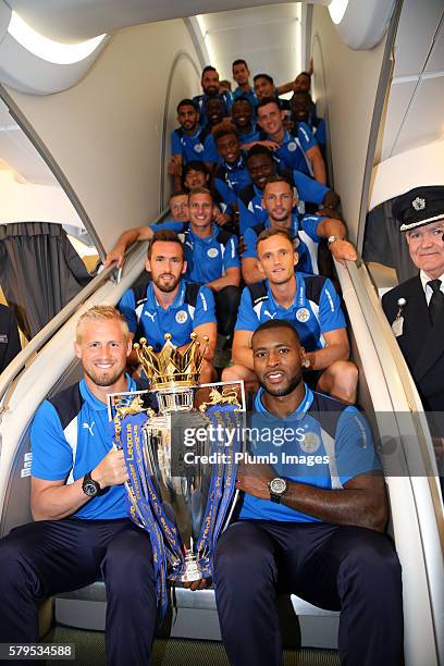 Leicester City players hold the Premier League trophy onboard as the Leicester City squad set off on their pre-season tour of America at Heathrow...