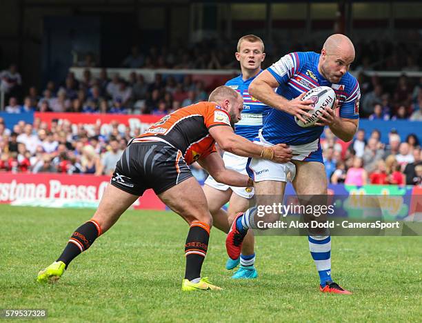 Wakefield's Liam Finn tries to get away from Castleford's Paul McShane during the First Utility Super League Round 23 match between Wakefield Trinity...