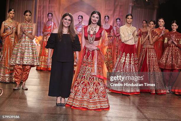 Indian fashion designer Reynu Taandon along with Bollywood actor Divya Khosla Kumar walks the ramp on day 3 of FDCI India Couture Week 2016 at The...
