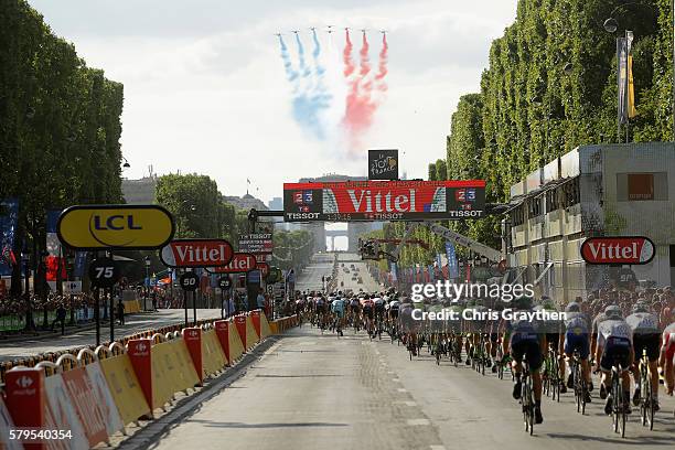 The pelaton aproach the Arc de Triomph as an air display show the French flag during stage twenty one of the 2016 Le Tour de France, from Chantilly...