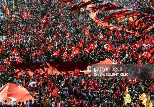 Supporters of various political parties shout slogans and hold Turkish flags and pictures of Ataturk, founder of modern Turkey, in Istanbul's Taksim...