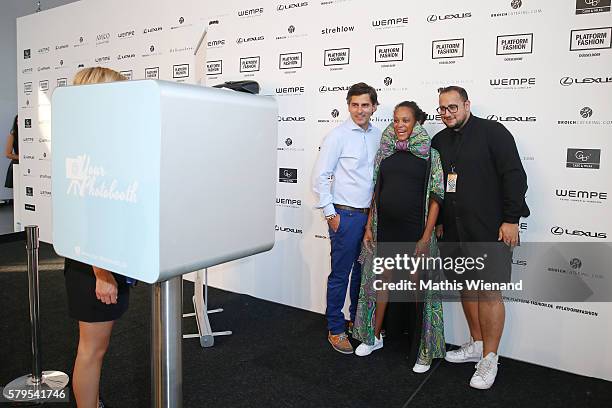 Robert Irschara, Milka Loff Fernandes and a guest pose infront of a photobooth ahead of the Platform Fashion Selected show during Platform Fashion...