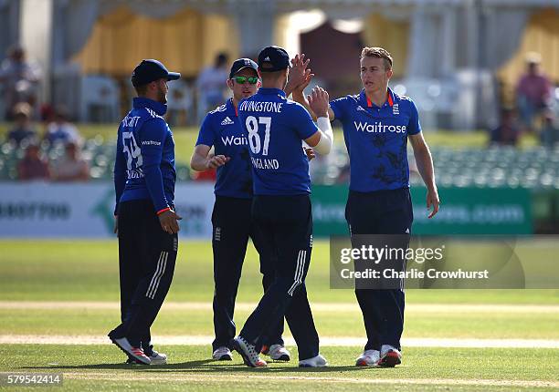 Tom Curran of England celebrates with team mates after taking the wicket of Saud Shakeel of Pakistan during the Triangular Series match between...