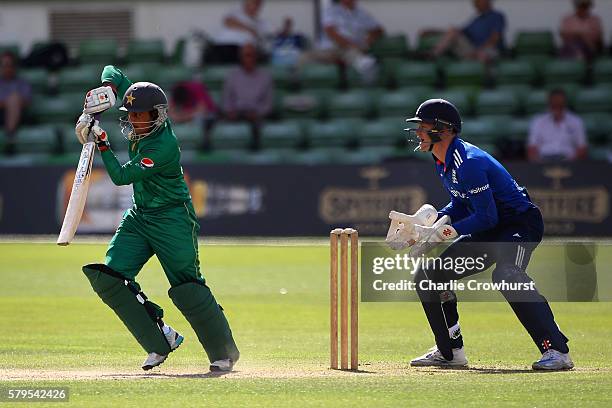 Saud Shakeel of Pakistan hits out while England Wicket keeper Sam Billings looks on during the Triangular Series match between England Lions and...